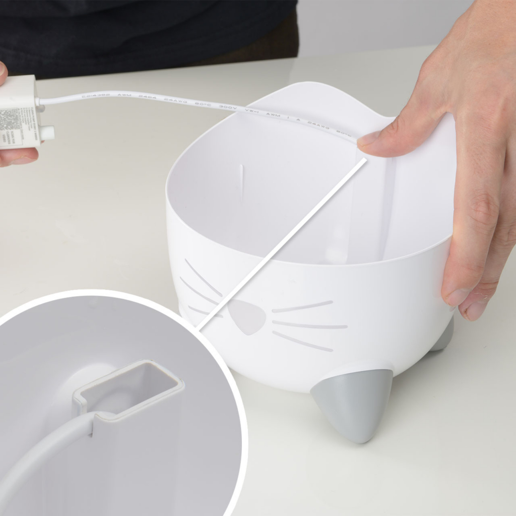 hands clicking cord of the PIXI mini fountain in place