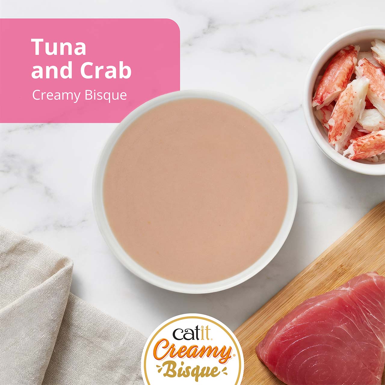 Catit Creamy Bisque cat treat in Tuna with Crab flavor, featuring a bowl of bisque, crab meat, and a tuna fillet