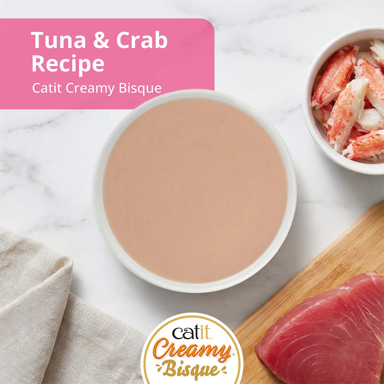 Catit Creamy Bisque cat treat in Tuna with Crab flavor, featuring a bowl of bisque, crab meat, and a tuna fillet