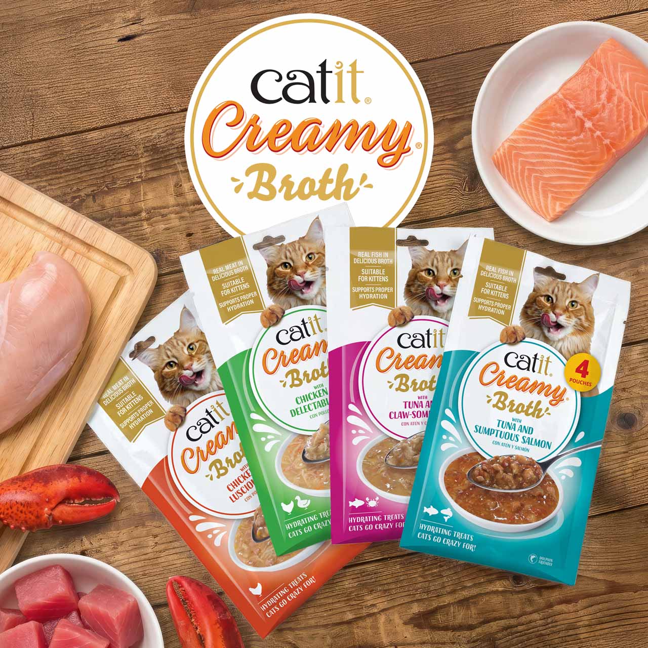 All Creamy Broth packaging on wooden counter with fresh ingredients and logo top view