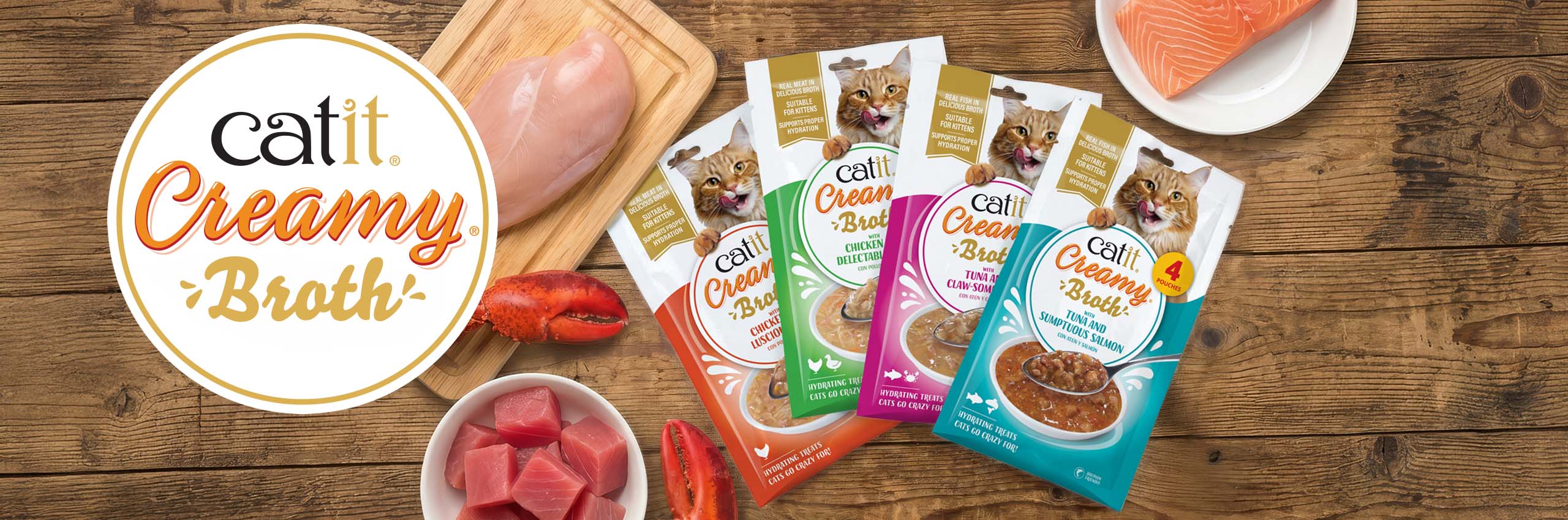 All Creamy Broth packaging on wooden counter with fresh ingredients and logo top view